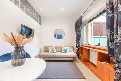 a living room with a couch and a table at Vatican Museums Apartment with Romantic Terrace in Rome