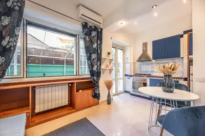 a kitchen with a table and a large window at Vatican Museums Apartment with Romantic Terrace in Rome