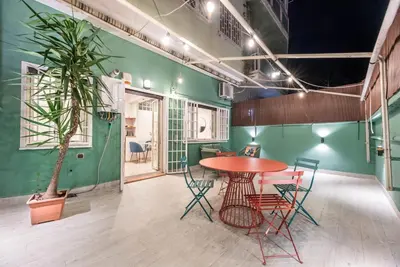 a table and chairs in a room with a plant at Vatican Museums Apartment with Romantic Terrace in Rome