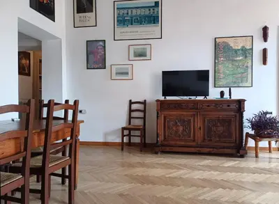 a living room with a television on a wooden cabinet at Del Cinque Heritage - Charme Holidays in Rome