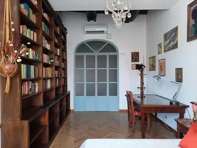 a room with a desk and a book shelf with books at Del Cinque Heritage - Charme Holidays in Rome