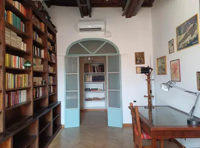 an archway in a room with a desk and book shelves at Del Cinque Heritage - Charme Holidays in Rome