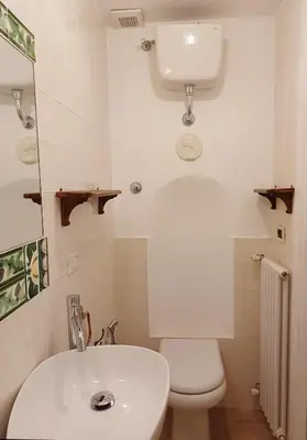 a white bathroom with a toilet and a sink at Del Cinque Heritage - Charme Holidays in Rome