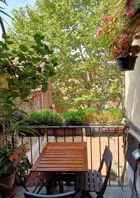 a wooden bench sitting on a balcony with plants at Del Cinque Heritage - Charme Holidays in Rome