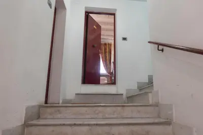 a set of stairs with a door and a mirror at La Dolce Vita Pantheon Suite in Rome