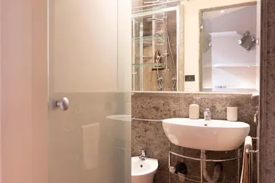 a bathroom with a sink and a mirror at La Dolce Vita Pantheon Suite in Rome