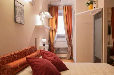 a room with a bed and a couch and a window at La Dolce Vita Pantheon Suite in Rome