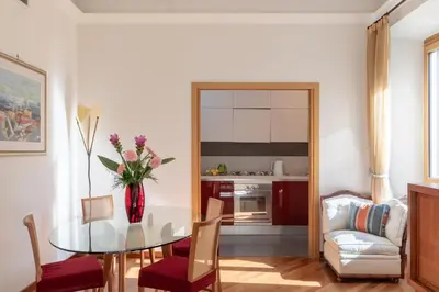 a dining room with a table with a vase of flowers at iFlat Vintage Retreat - Comfort in Central Rome in Rome