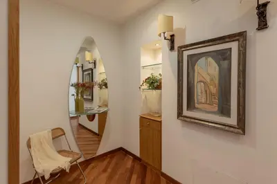 a room with a painting on the wall and a chair at iFlat Vintage Retreat - Comfort in Central Rome in Rome