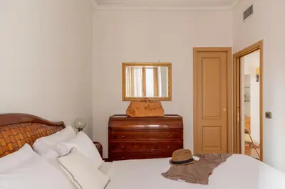 a bedroom with a bed with a mirror and a dresser at iFlat Vintage Retreat - Comfort in Central Rome in Rome