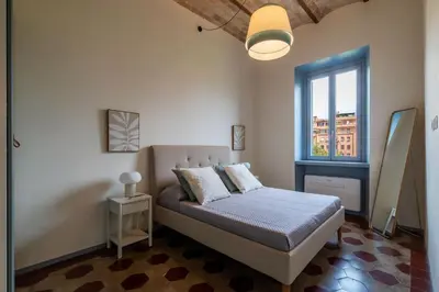 a bedroom with a bed and a window at GuestHost - Elegant Apartment Testaccio Roma in Rome