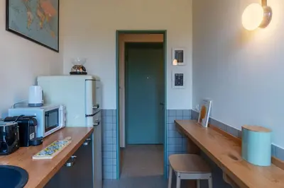 a kitchen with a counter with a refrigerator at GuestHost - Elegant Apartment Testaccio Roma in Rome