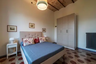 a bedroom with a bed with a blue comforter at GuestHost - Elegant Apartment Testaccio Roma in Rome