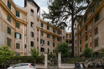 a car parked in front of a row of buildings at GuestHost - Elegant Apartment Testaccio Roma in Rome