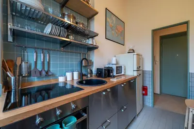 a kitchen with a counter top with a sink at GuestHost - Elegant Apartment Testaccio Roma in Rome