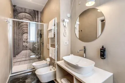 a bathroom with a sink and a toilet and a mirror at Madonna del Pantheon in Rome