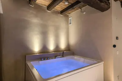 a bathroom with a large bath tub in the corner at Madonna del Pantheon in Rome