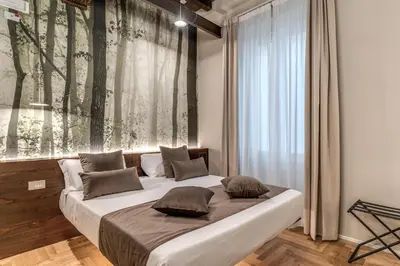 a bedroom with a bed with a large window at Madonna del Pantheon in Rome