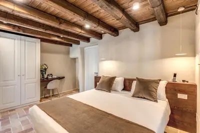 a bedroom with a large bed and a desk at Madonna del Pantheon in Rome
