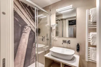 a bathroom with a sink and a glass shower at Madonna del Pantheon in Rome