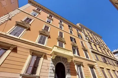 a large yellow building with a lot of windows at Maison Florienne in Rome