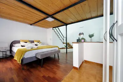 a bedroom with a bed and a wooden ceiling at Maison Florienne in Rome