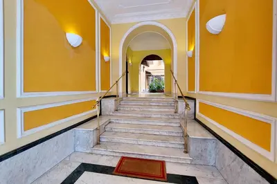 a staircase in a building with yellow walls at Maison Florienne in Rome