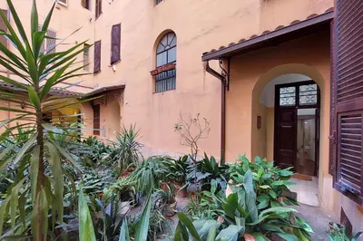 a building with a bunch of plants in front of it at Maison Florienne in Rome