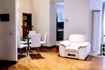 a living room with white chairs and a table at Callimaco Domus in Rome