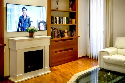 a living room with a fireplace and a tv at Callimaco Domus in Rome