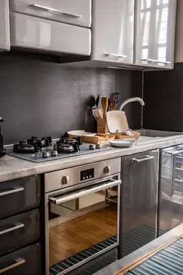 a kitchen with a stainless steel stove and a sink at Callimaco Domus in Rome