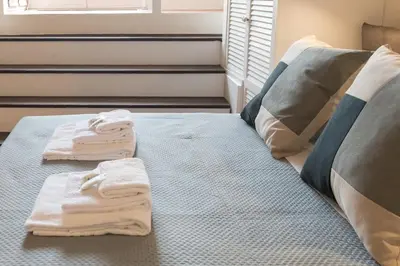 a bed with two towels sitting on top of it at Lungaretta Trastevere Penthouse Mimì & Cocò Home in Rome