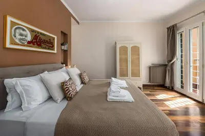 a bedroom with a large bed with white pillows at Lungaretta Trastevere Penthouse Mimì & Cocò Home in Rome