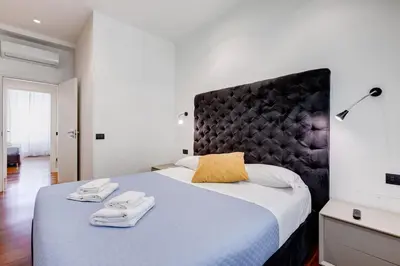 a bedroom with a large bed with towels on it at Luxury Ludo House Trastevere in Rome