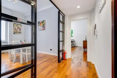 a hallway with a glass door leading to a dining room at Luxury Ludo House Trastevere in Rome