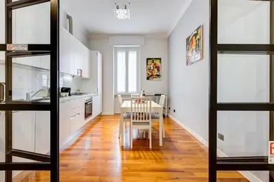 a kitchen with a table and a dining room at Luxury Ludo House Trastevere in Rome