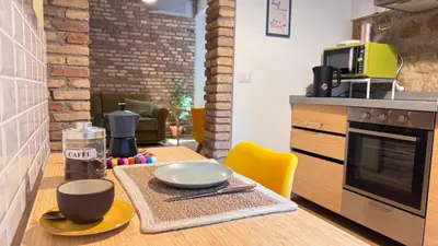 a kitchen with a table with two plates and cups on it at Quiet Loft Monteverde Roma in Rome