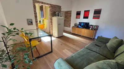 a living room with a couch and a refrigerator at Quiet Loft Monteverde Roma in Rome