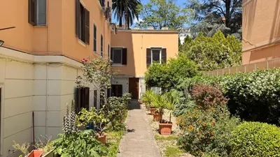 a garden in front of a house with plants at Quiet Loft Monteverde Roma in Rome