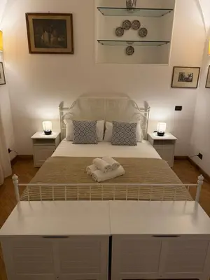 a bedroom with a bed with two towels on it at La casetta nel vicolo in Rome