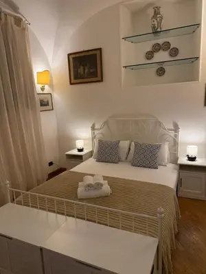 a bedroom with a bed with two towels on it at La casetta nel vicolo in Rome
