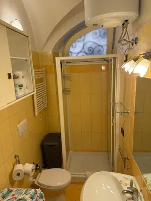 a bathroom with a shower and a toilet and a sink at La casetta nel vicolo in Rome