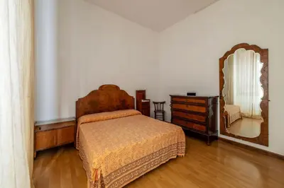 a bedroom with a bed and a dresser and a mirror at GuestHost - Comfy Apartment Garbatella Roma in Rome