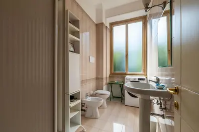 a bathroom with a sink and a toilet and a window at GuestHost - Comfy Apartment Garbatella Roma in Rome