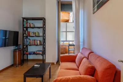 a living room with a couch and a tv at GuestHost - Comfy Apartment Garbatella Roma in Rome