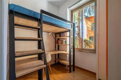 a bunk bed in a room with a window at GuestHost - Comfy Apartment Garbatella Roma in Rome