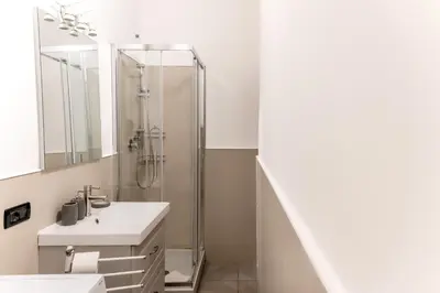a bathroom with a sink and a shower at Key Apartment Obelisco in Rome