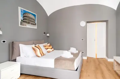 a white bedroom with a bed in a room at Key Apartment Obelisco in Rome