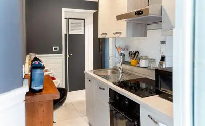 a kitchen with a sink and a stove top oven at Key Apartment Obelisco in Rome