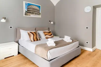 a bedroom with a large bed with towels on it at Key Apartment Obelisco in Rome